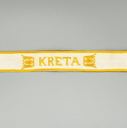 Kreta Cuff Title, constructed in white cotton, with flanking Kreta Cuff Title, constructed in white cotton with flanking acanthus leaves