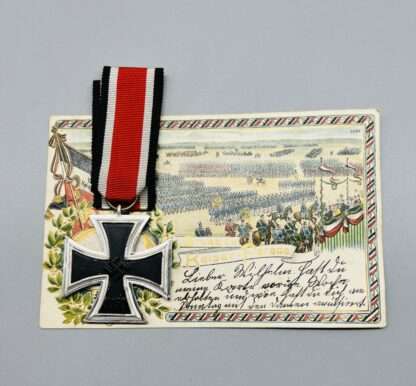A WW2 Iron Cross 2nd Class with nice silver frame, and blackened iron core, with a postcard.