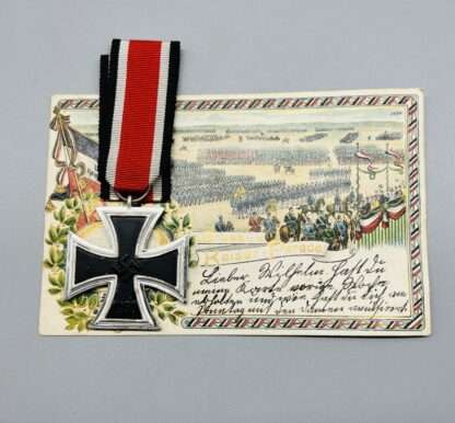 A WW2 Iron Cross 2nd Class with nice silver frame, and blackened iron core, with a postcard.