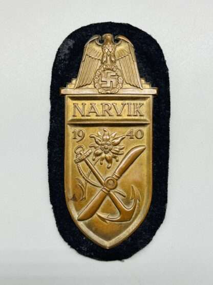 A Kriegsmarine Narvik Shield with blue cloth backing.