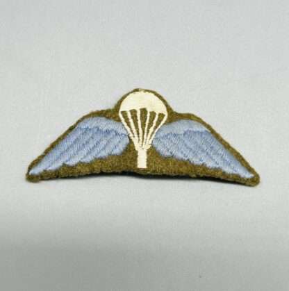 A WW2 British Paratrooper Jump Wings embroidered in cloth on Khaki backing.
