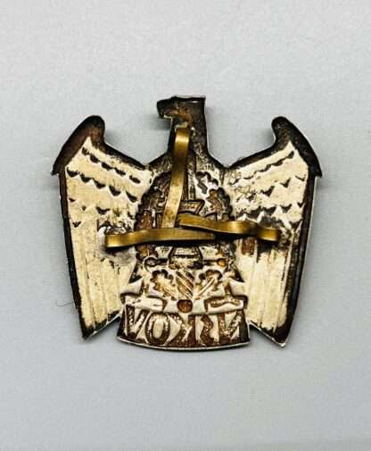 A NSKOV Visor Cap Eagle Badge, reverse image with prongs.