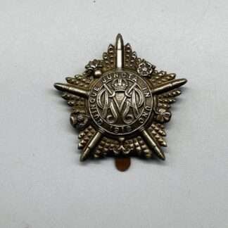 A WW1 Guards Machine Gun Regiment Cap Badge, constructed in white metal.