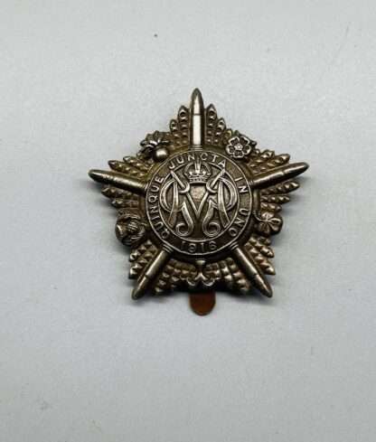 A WW1 Guards Machine Gun Regiment Cap Badge, constructed in white metal.