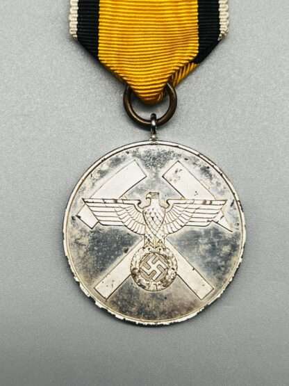 A Scarce WW2 German Mine Rescue Honour Medal with yellow, black, and white ribbon.