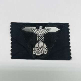 A Waffen-SS Panzer M43 Trapezoid BeVo flat wire construction in silver thread on black backing which depicts a SS National Eagle with a skull below.