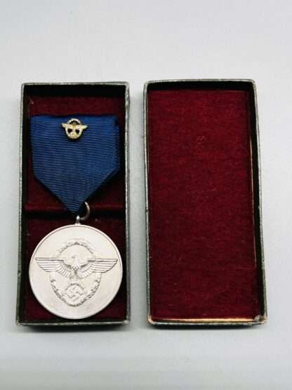 A WW2 German Police Long Service Medal 8 Years, constructed in silvered tombac with period blue ribbon with police motif in the centre. complete with presentation box lined in red felt.