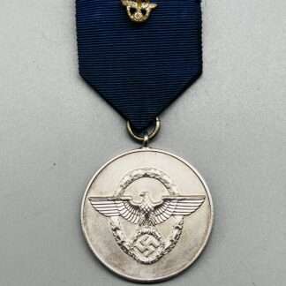 A WW2 German Police Long Service Medal 8 Years, constructed in silvered tombac with period blue ribbon with police motif in the centre.