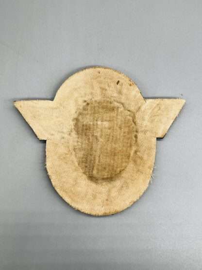 A reverse photo of a WW2 German Polizei General Officer Sleeve Eagle Badge.