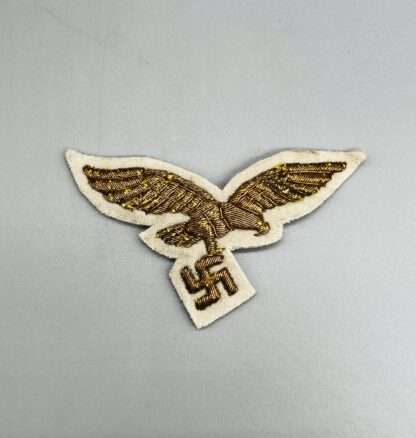 A Luftwaffe General's Summer Breast Eagle embroidered in gold bullion on white backing.
