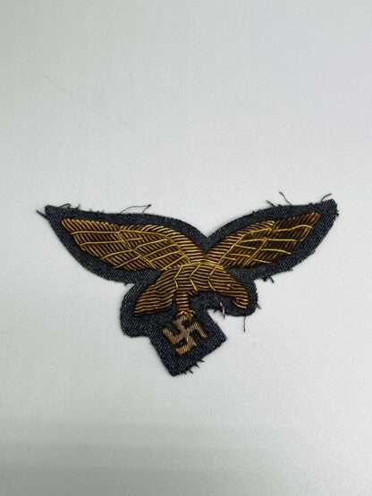 A Luftwaffe General's Summer Breast Eagle,  hand-embroidered in gold bullion on blue backing.