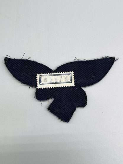 A reverse photo of a Luftwaffe General's Summer Breast Eagle with tailors paper marked "69814".