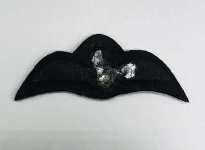 A reverse photo of A rare WW2 Royal Rhodesian Air Force Pilot Wings, padded with black backing.