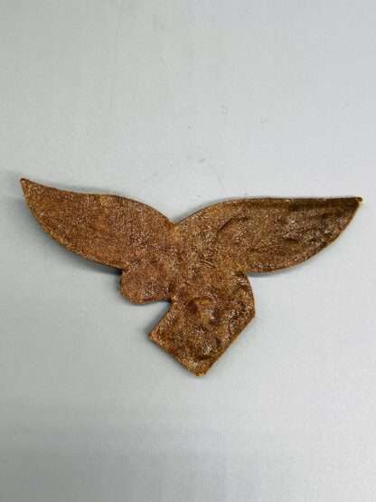 A reverse image of Luftwaffe Officer's Tropical Breast Eagle, with tan backing.