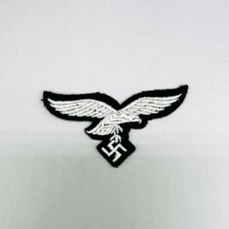 A Luftwaffe Herman Göring Panzer-Division cap eagle,  machine embroidered eagle in white/grey rayon on black wool backing