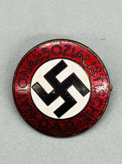 An original late-war NSDAP Party Badge RZM M1/72 pin badge, constructed in white, red, black, and gold enamel.
