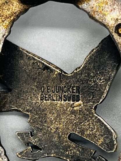A reverse photo of Luftwaffe Air Gunner and Radio Operators Badge with makers mark C.E. Juncker Berlin SW68.