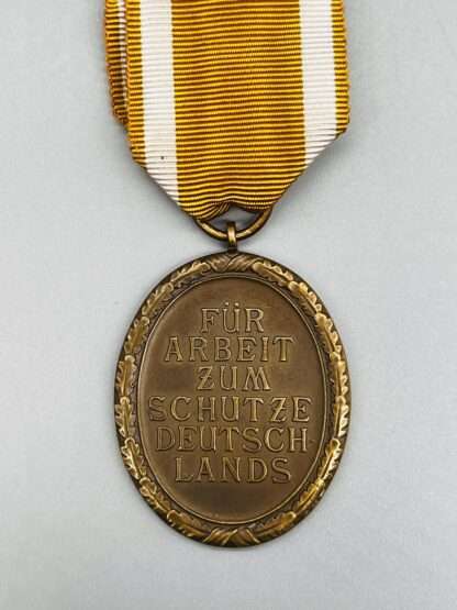A reverse image of a WW2 Geman West Wall Medal.