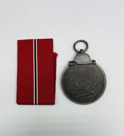 A reverse image of WW2 German Eastern Front Ostmedaille with ribbon.