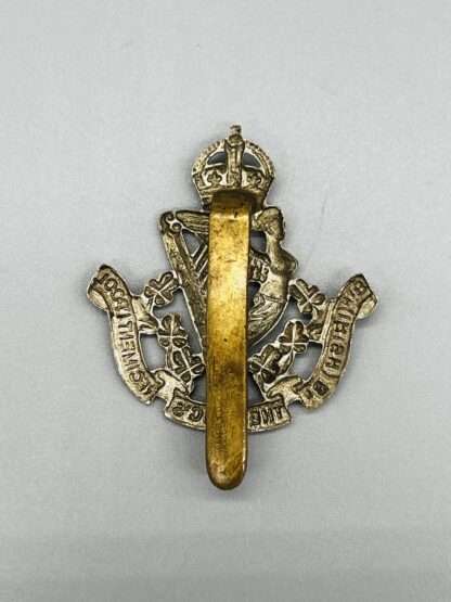 Reverse image of a WW2 British 8th (Irish) Battalion the King's Liverpool Regiment Cap Badge, constructed from white metal with brass slider.