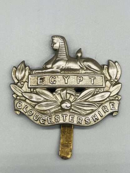 A WW1 British Gloucestershire Regiment Cap Badge, constructed in white metal.