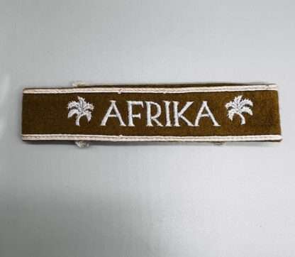 An original WW2 German Heer Afrika Korp cuff title machine embroidered in silver, with silver braid.
