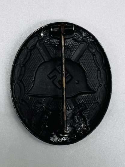 A reverse image black wound badge.