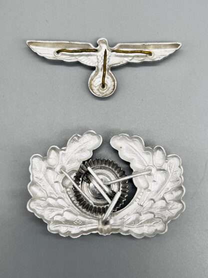 Reverse image of a A Heer Cockade Wreath & Visor Cap Eagle, die-stamp construction in zinc.