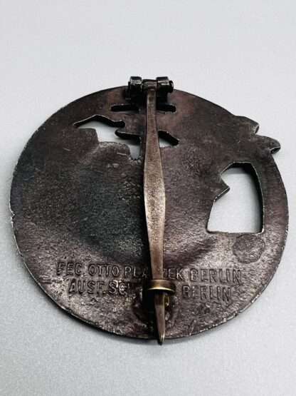 A reverse image of a German Blockade Runners Badge With makers mark By Fec. Otto Placzek.
