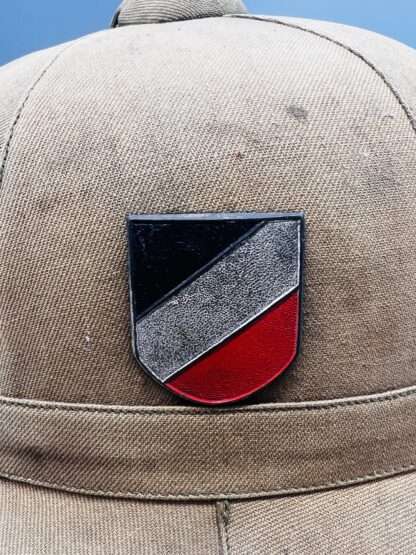 A WW2 German Heer Afrika Korp pith helmet tri-colour shield.