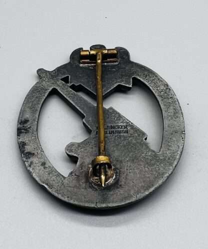 A WW2 German Heer Flak Badge By C.E. Juncker, constructed in zinc, with barrel hinge and soldered round catch.
