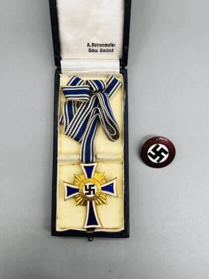 A WW2 German Mother's Cross Gold with presentation case and NSDAP pin.