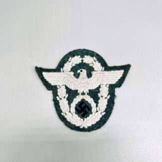 A WW2 German Police Administration EM/NCO Sleeve Eagle, embroidered in grey thread on green backing.