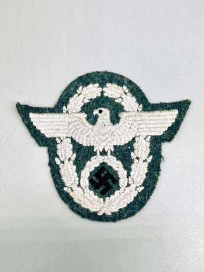 A WW2 German Police Administration EM/NCO Sleeve Eagle, embroidered in grey thread on green backing.