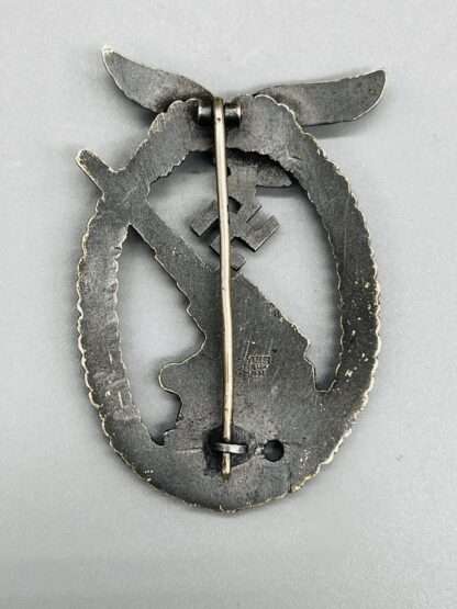 A revesre image of a WW2 Luftwaffe Flak Badge by Gustav Brehmer, constructed in tombak with makers mark.