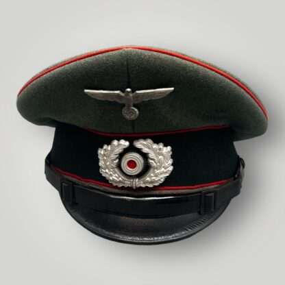 A WW2 German Heer Flak EM/NCOs visor cap, with red pipping and insignia.