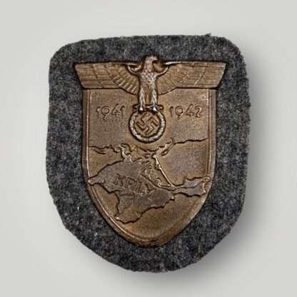 A Luftwaffe Krim Campaign Shield with bronze finish, and blue grey fabric.