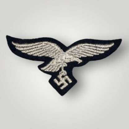 A WW2 Luftwaffe EM/NCO's Herman Göring Panzer-Division breast eagle, machine embroidered with silver thread on black wool backing.