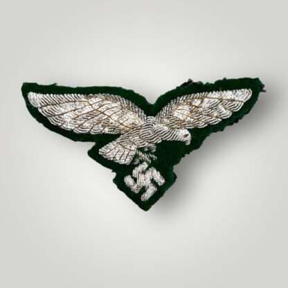 A rare WW2 German Luftwaffe forestry officer's bullion breast eagle, hand embroidered in silver bullion on green woollen backing.