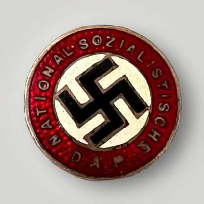 A NSDAP Party Badge unmarked, constructed in enamel.