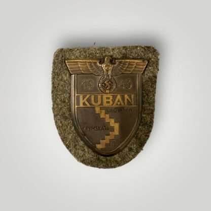 An original Heer Kuban shield in mint condition, with field green cloth backing.