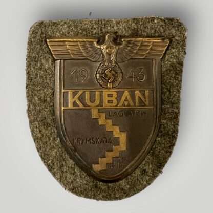 An original Heer Kuban shield in mint condition, with field green cloth backing.