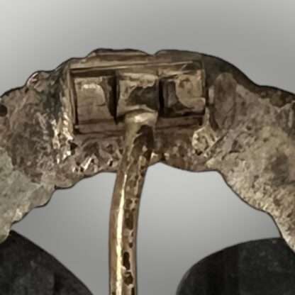 A close up image of the hinge for a Luftwaffe Observer's Badge by Assmann & Söhne.
