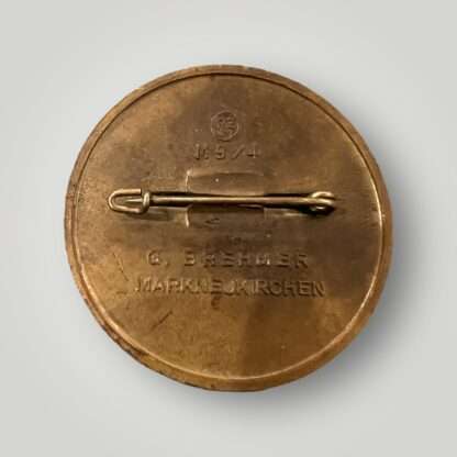 An reverse image of an original Reichsparteitag 1939 day badge, constructed in zinc with bronze finish complete with safety pin assembly.