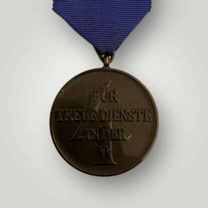 A SS service medal four years complete with original ribbon.