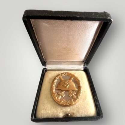 An original WW2 German Gold Wound badge tombak by Karl Wild, constructed in tombak placed in presentation case.