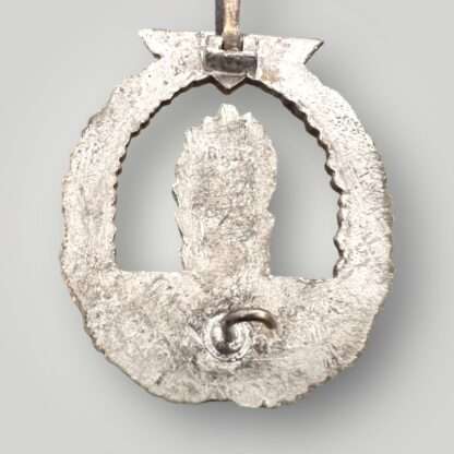 A Kriegsmarine Minesweepers War Badge by Rudolf Kaneth marked 'R.K.'. with integral hinge.