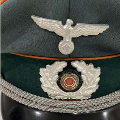 A Heer Feldgendarmerie Officer's visor cap insignia.
