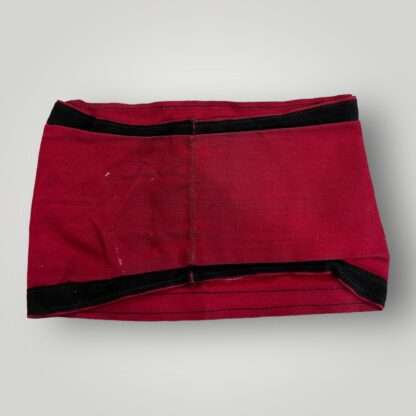 Reverse image of a Allgemeine SS Armband, two part construction on red cotton trimmed with black cotton strip top and bottom.