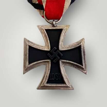 An Iron Cross 2nd Class Medal unmarked, with red, white, and black ribbon.